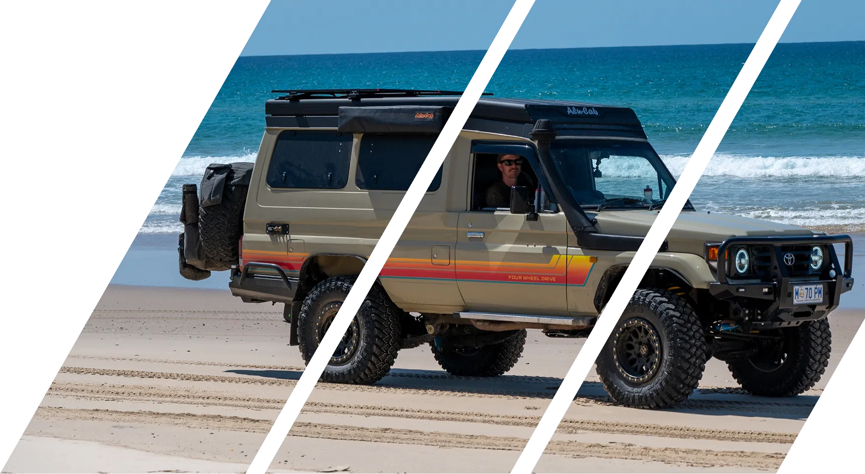 Beige four-wheel-drive SUV parked on sandy beach with ocean waves in the background.